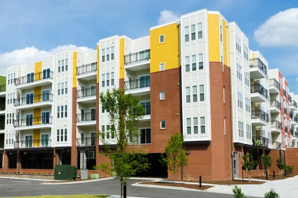 Modern apartment building with parking garage — Stock Photo, Image