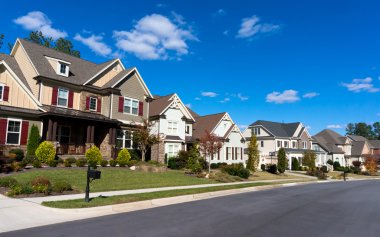 Street of large suburban homes clipart