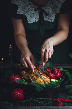 Christmas duck with pomegranates and lime surrounded by spruce branch