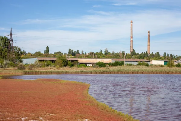 Technical settler of industrial water of mining industry in Kryvyi Rih, Ukraine. Redwater is polluted with iron ore waste. Discharge of process water in the sump after the iron ore beneficiation