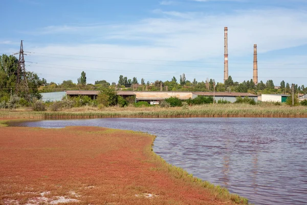 Technical settler of industrial water of mining industry in Kryvyi Rih, Ukraine. Redwater is polluted with iron ore waste. Discharge of process water in the sump after the iron ore beneficiation