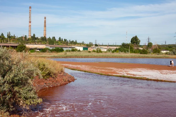 Technical settler of industrial water of mining industry in Kryvyi Rih, Ukraine. Redwater is polluted with iron ore waste. Discharge of process water in the sump after the iron ore beneficiation