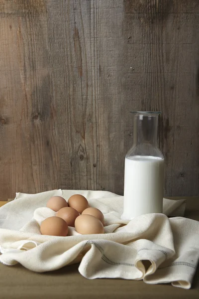 Eggs and milk on kitchen counter — Stock Photo, Image