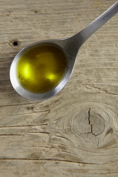 Spoon full of olive oil — Stock Photo, Image