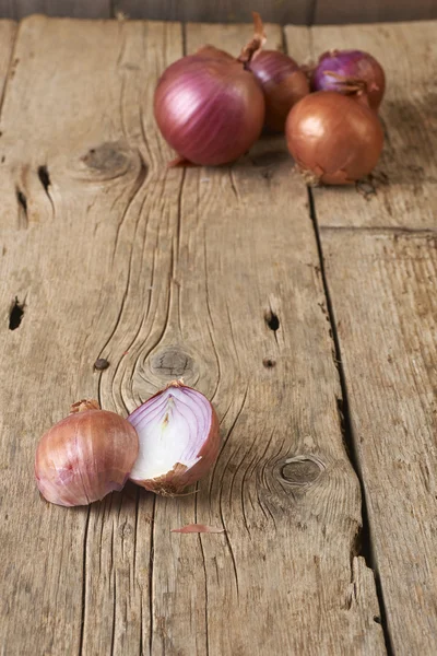 Purple onions on wooden table — Stock Photo, Image