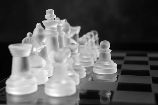 Glass chess board with chess pieces — Stock Photo, Image