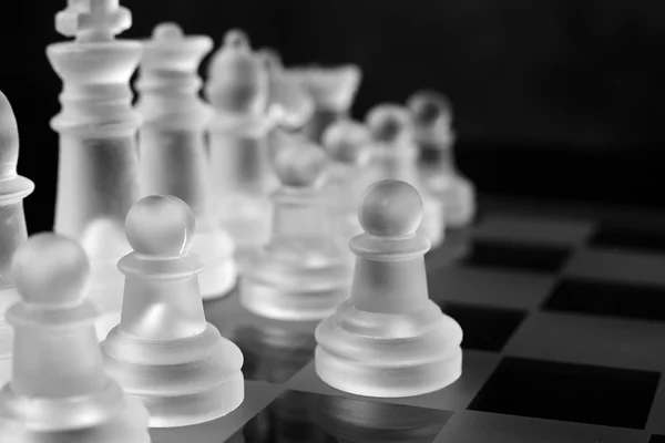 Glass chess board with chess pieces — Stock Photo, Image