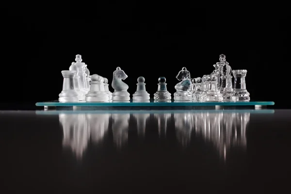 Glass chess board with chess pieces — Stock Photo, Image