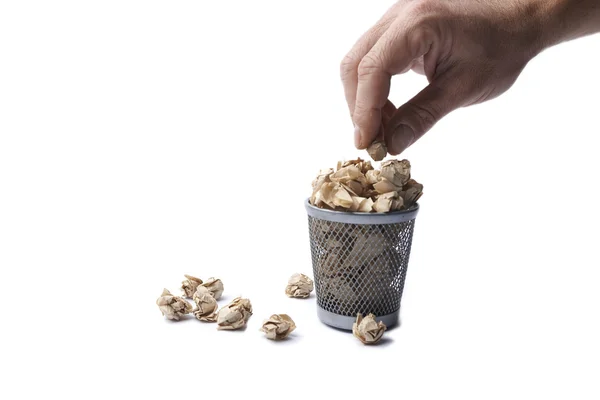 Man's hand put paper in iron trash bin, isolated on white backgr — Stock Photo, Image