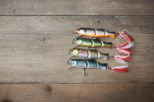 Colorful lures on the wooden pier — Stock Photo, Image