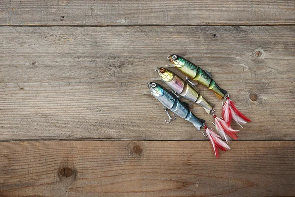 Colorful lures on the wooden pier — Stock Photo, Image