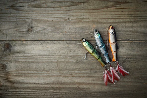 Colorful lures on the wooden pier — Stock Photo, Image