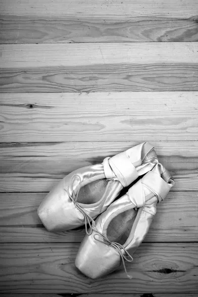 Pair of ballet shoes pointes on wooden floor — Stock Photo, Image