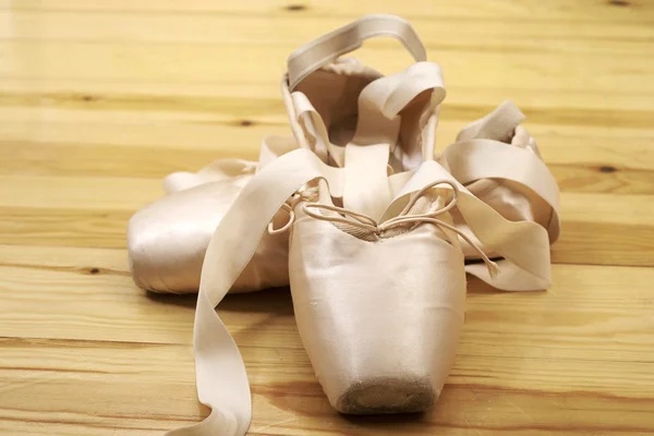 Par de zapatos de ballet pointes en piso de madera — Foto de Stock