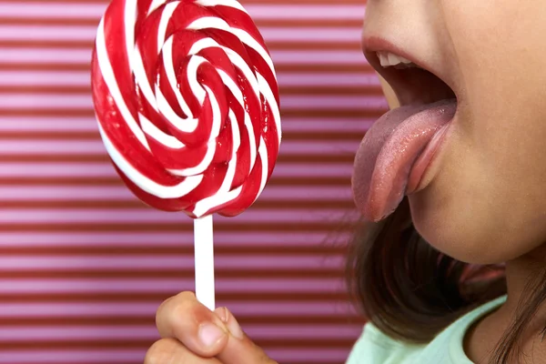 girl enjoy licking a lollipop.