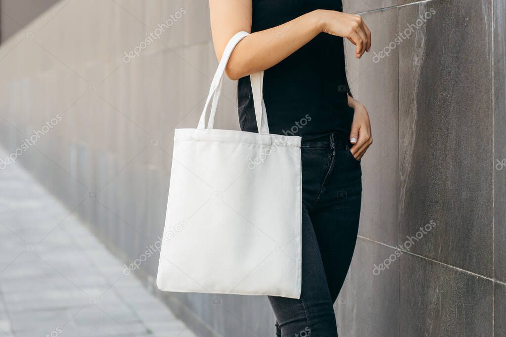 Young asian model  girl on the street holding white eco bag, mock up