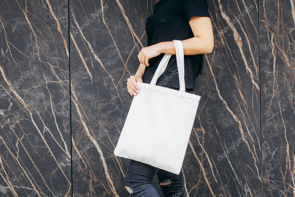 Young asian model  girl on the street holding white eco bag, mock up