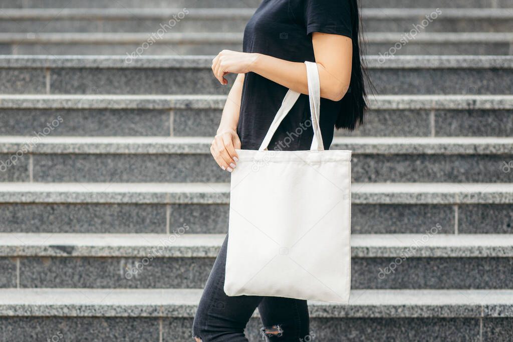 Young asian model  girl on the street holding white eco bag, mock up