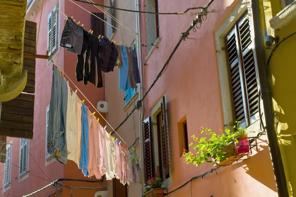 Colored laundry hanging out on a clothesline in the street — Stock Photo, Image