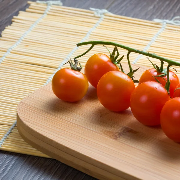 Fresh tomatoes on vintage wooden table — Stock Photo, Image