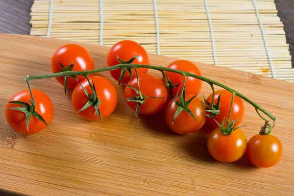 Fresh tomatoes on vintage wooden table — Stock Photo, Image
