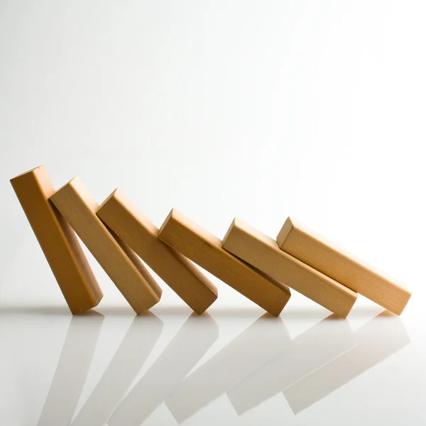 Domino effect - row of white dominoes on white background — Stock Photo, Image