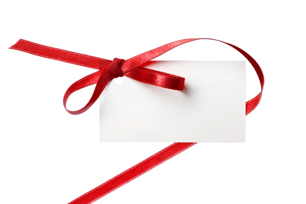 Blank gift tag tied with a bow of red satin ribbon. Isolated on white, with soft shadow — Stock Photo, Image