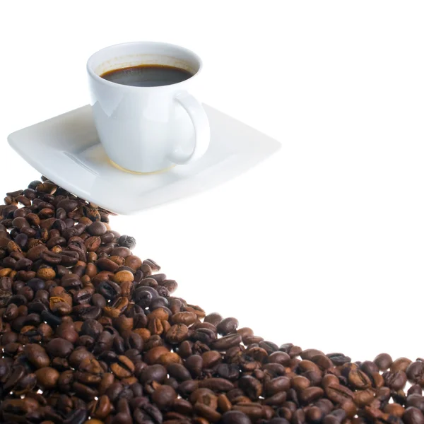 Xícara de café e grãos no fundo branco — Fotografia de Stock