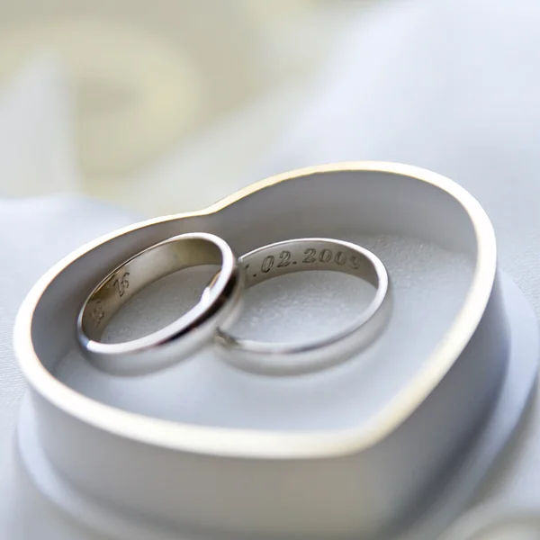 Anéis de casamento de ouro com caixa em forma de coração — Fotografia de Stock
