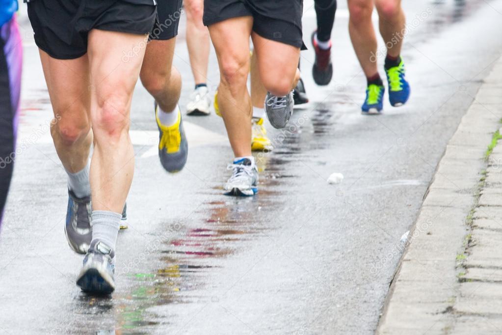 detail of the legs of runners at the start of a marathon race