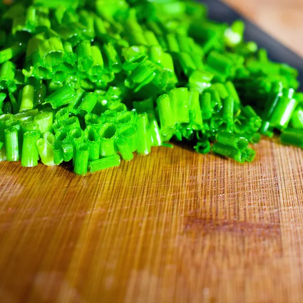 Chives on a wooden surface — Stock Photo, Image