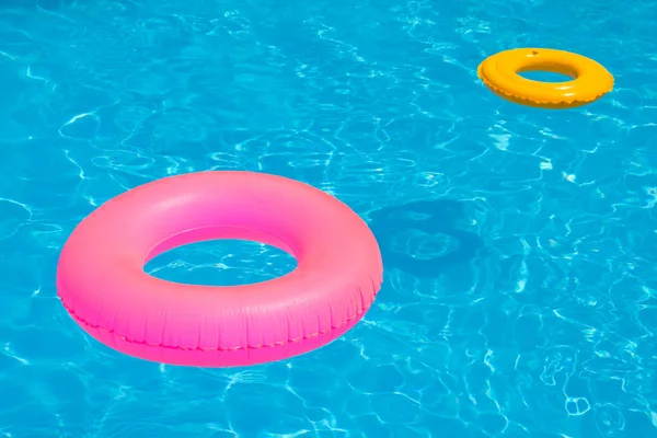 Float ροζ πισίνα, πισίνα δαχτυλίδι στο δροσερό μπλε δροσιστικό μπλε λίμνη — Φωτογραφία Αρχείου