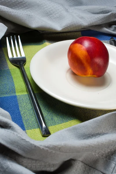 Red ripe nectarine peaches on white plate — Stock Photo, Image