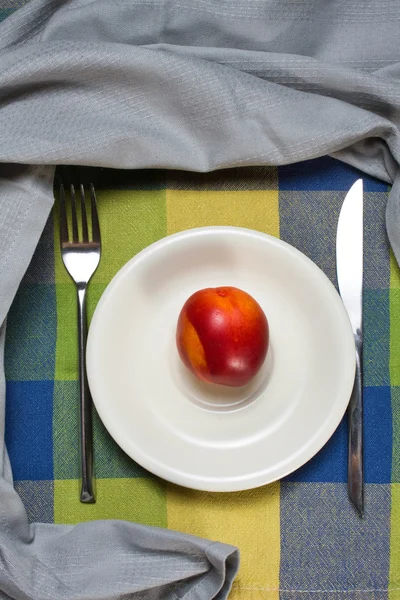 Red ripe nectarine peaches on white plate — Stock Photo, Image
