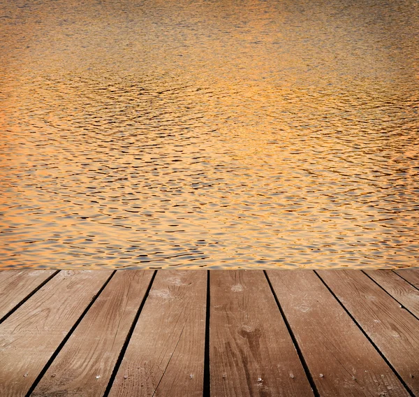 Beauty sunset over a wooden floor and the sea — Stock Photo, Image