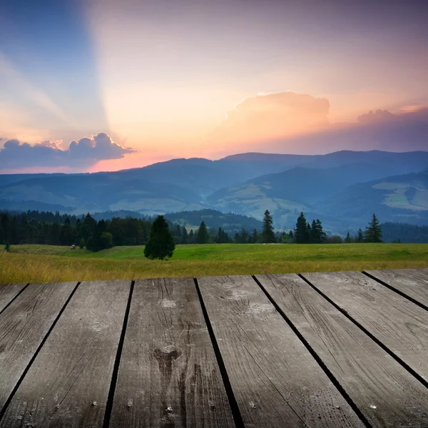 Sunrise in the mountains and empty wooden deck table. Ready for product montage display. — Stock Photo, Image