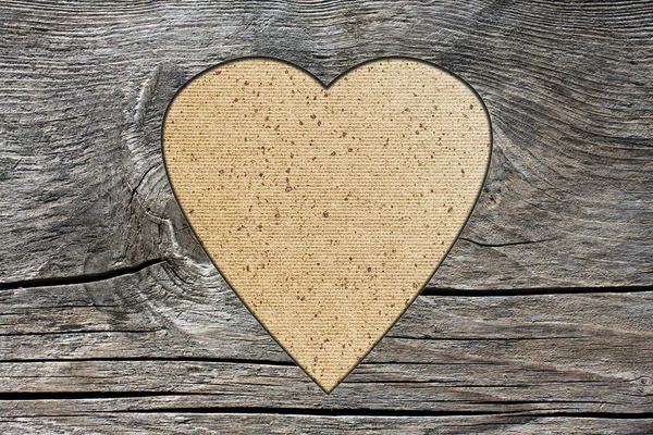 Sfondo con un foro a forma di cuore e vecchia tavola di legno — Foto Stock