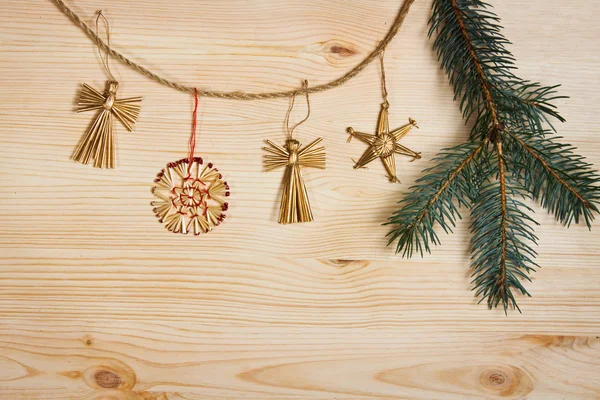 Christmas decorations hanging over wooden background — Stock Photo, Image