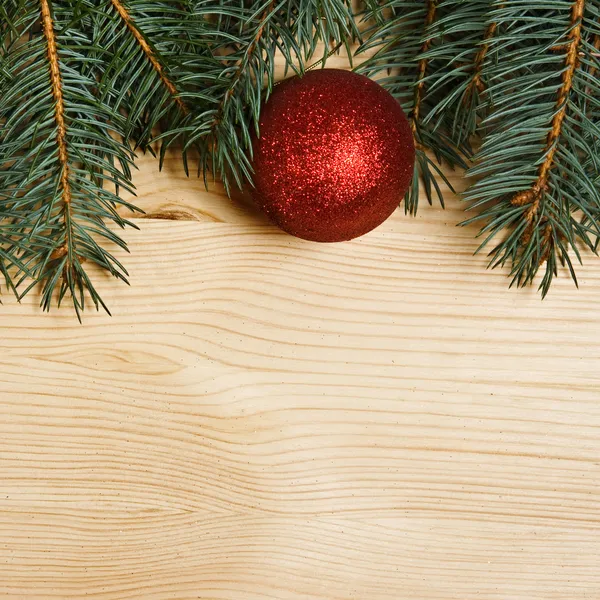 Christmas fir tree with decoration on a wooden board — Stock Photo, Image