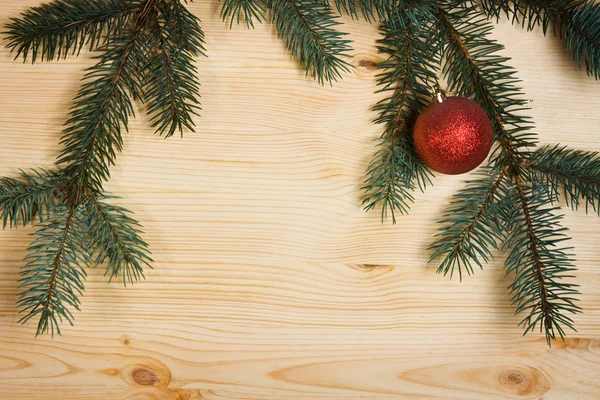 Christmas fir tree with decoration on a wooden board — Stock Photo, Image