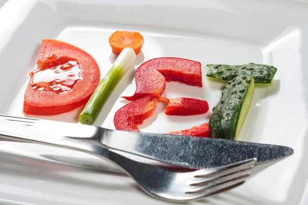 Plate with vegetables and word diet over wooden background — Stock Photo, Image