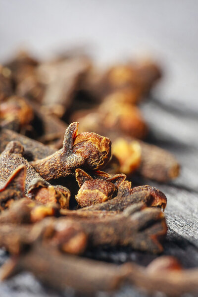 pile cloves on wood background