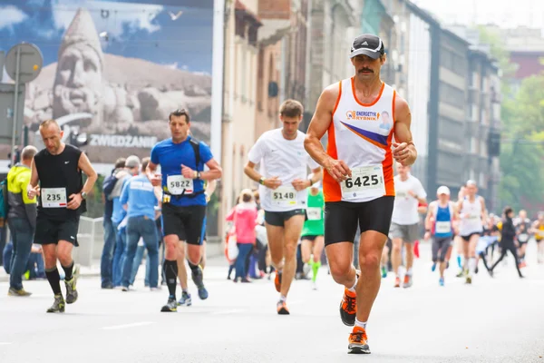 KRAKOW, POLONIA - 18 de mayo: Maratón de Cracovia. Corredores en las calles de la ciudad el 18 de mayo de 2014 en Cracovia, POLONIA — Foto de Stock