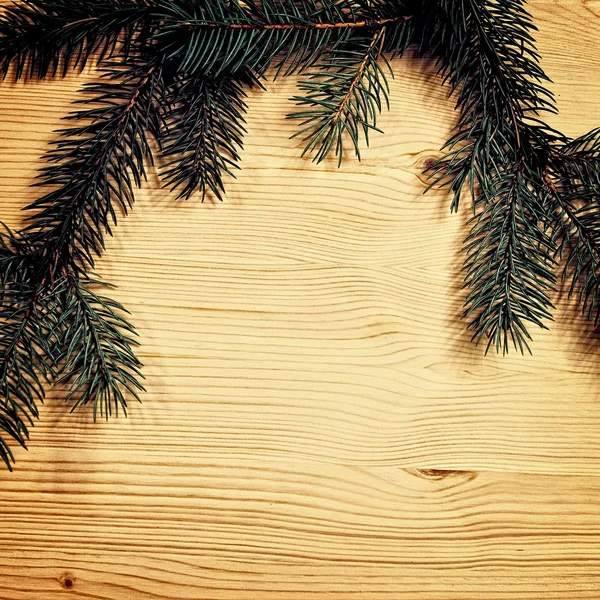 Christmas fir tree with decoration on a wooden board — Stock Photo, Image