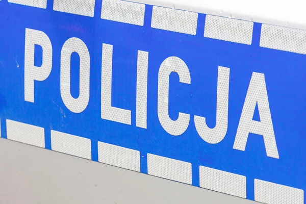 Polska policja znak na drzwiach samochodu policji — Zdjęcie stockowe
