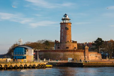 Kolobrzeg, Poland - December 31, 2020: harbor and the lighthouse in Kolobrzeg, West Pomerania, Poland clipart