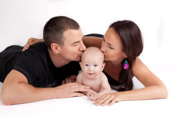 Happy family kiss - mother, father and baby — Stock Photo, Image