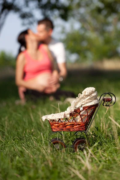 Focus small pram and young couple — Stock Photo, Image