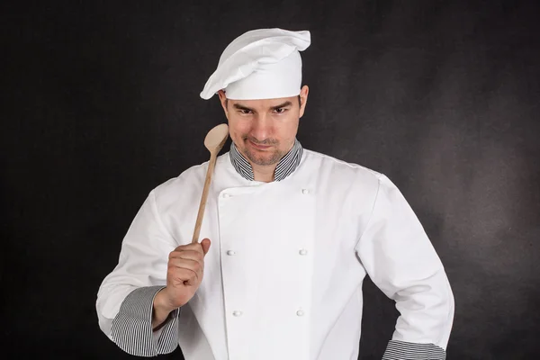 Chef holding wooden spoon — Stock Photo, Image