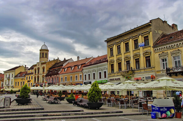 BRASOV, ROMANIA - JUNE 18, 2014: Tourists visit old town of Brasov on JUNE 18. The town is the 7th most populous city in Romania, The city is known as a birthplace of the national anthem of Romania.
